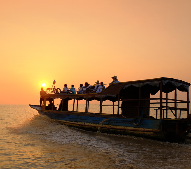 Tourists enjoying a sunset boat cruise at Tonle Sap floating village near J7 Hotel Siem Reap.