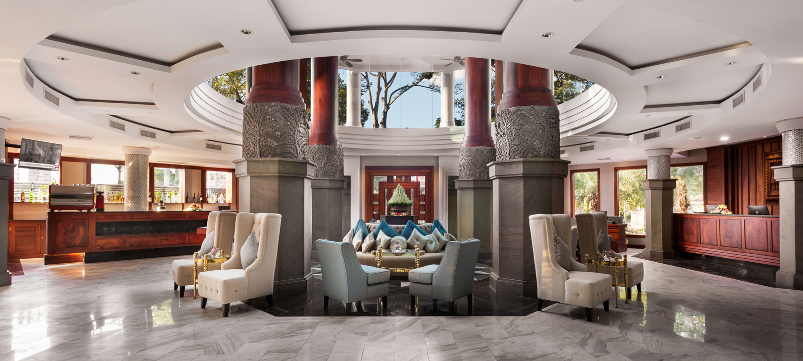 Grand luxury lobby and reception lounge at J7 Hotel Siem Reap with high-back armchairs, massive columns, and high ceilings